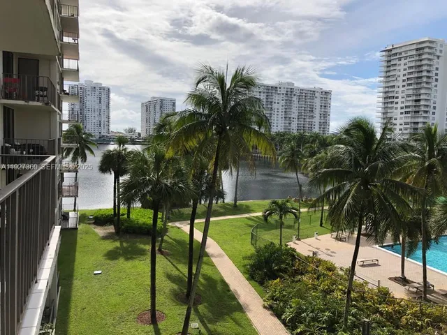a view of a hallway and a livingroom with a bathroom