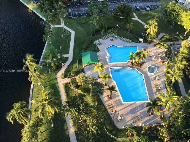 an aerial view of a house with swimming pool and patio