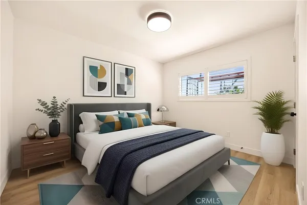 a bedroom with a bed and a window