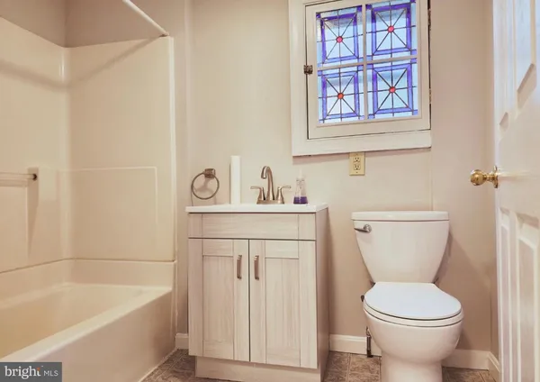 a bathroom with a sink a toilet and a bathtub