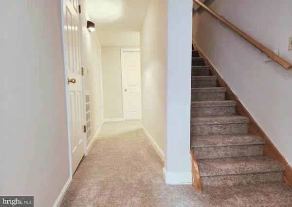 a view of a hallway with stairs