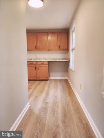 a view of a kitchen with a sink and cabinets
