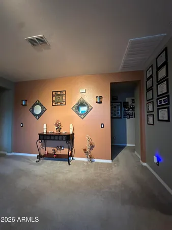 a living room with furniture and a gym machine