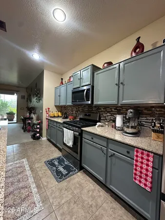 a kitchen with granite countertop a stove and a sink