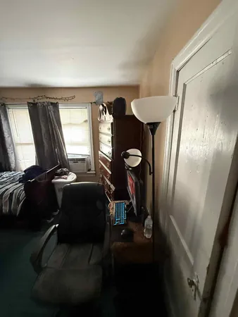 a living room with furniture and a mirror