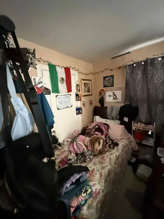a bedroom with bed and a couch