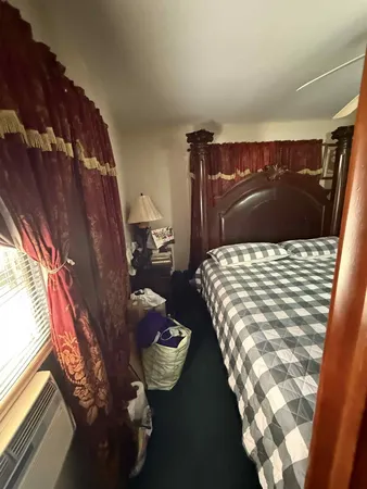 a bed sitting in a bedroom next to a window