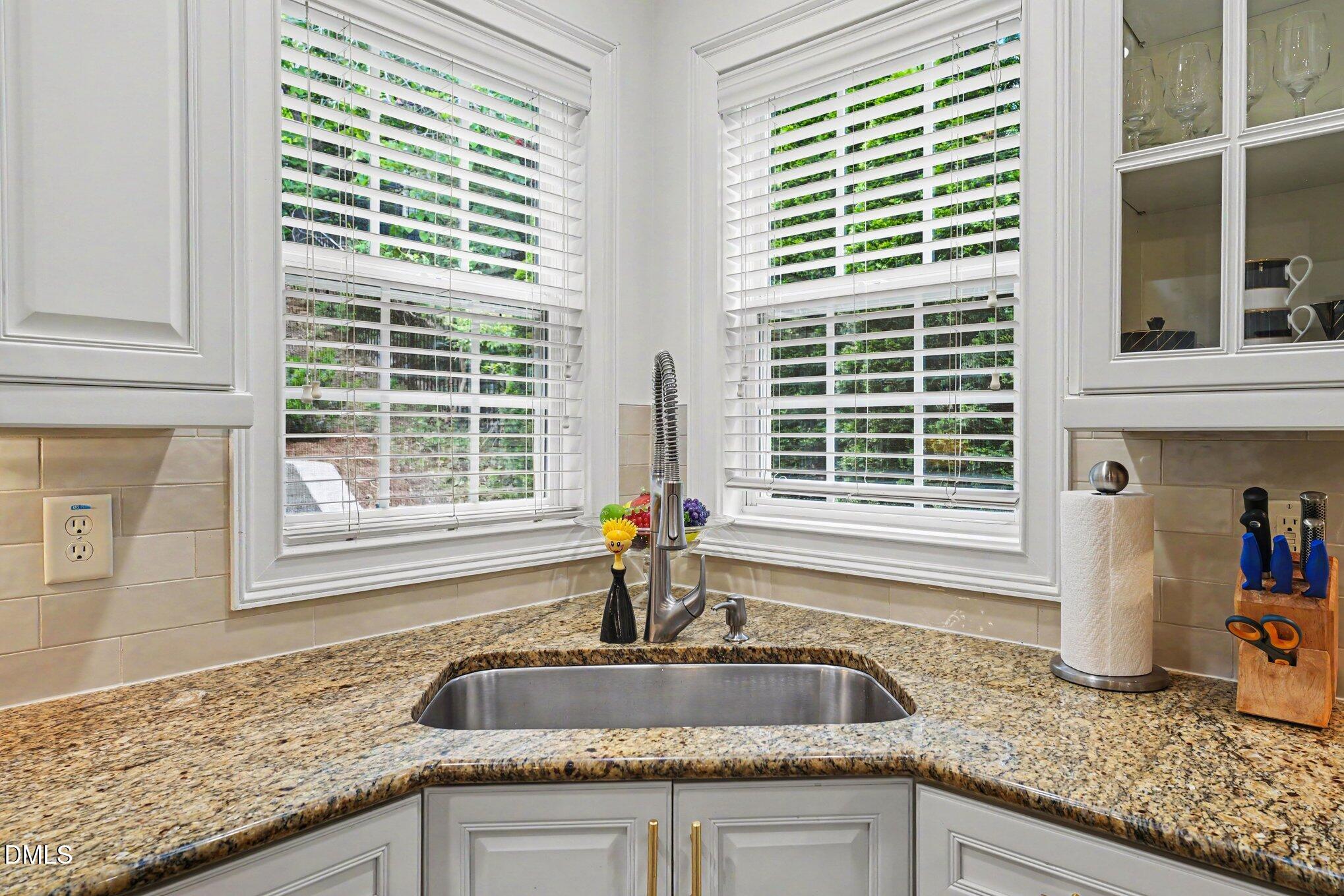 1729 Frenchwood Drive Raleigh, NC 27612 - Photo 10 of 46 a kitchen with granite countertop sink and window