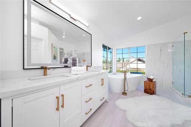 a bathroom with a granite countertop sink mirror and toilet