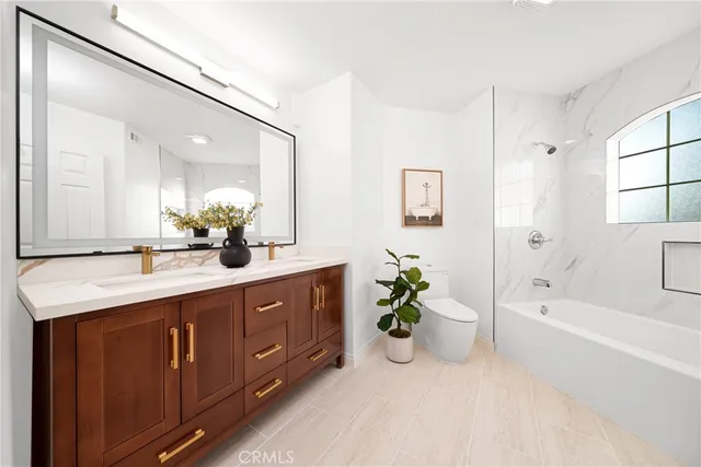 a spacious bathroom with a tub sink and mirror