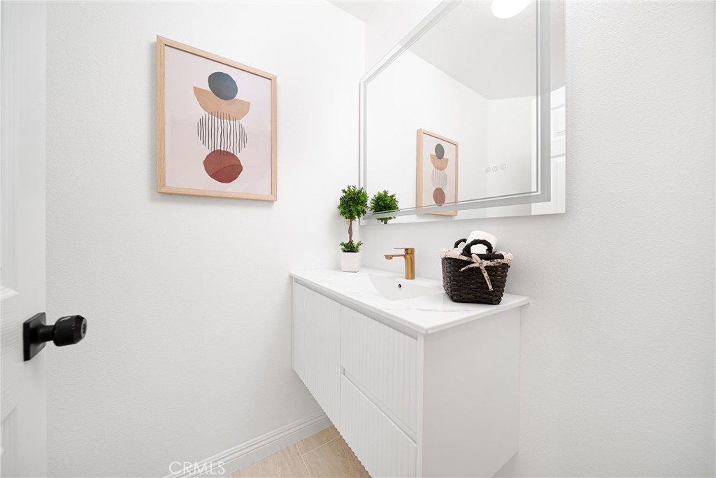 12982 Arapaho Road Rancho Cucamonga, CA 91739 - Photo 31 of 51 a bathroom with a sink and a mirror