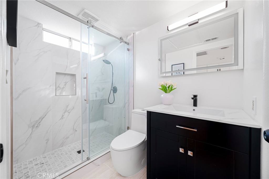 12982 Arapaho Road Rancho Cucamonga, CA 91739 - Photo 42 of 51 a bathroom with a sink a toilet and shower