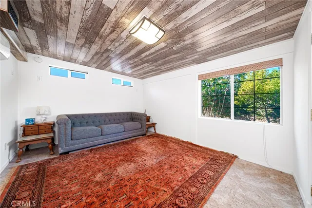 a bedroom with furniture and a window