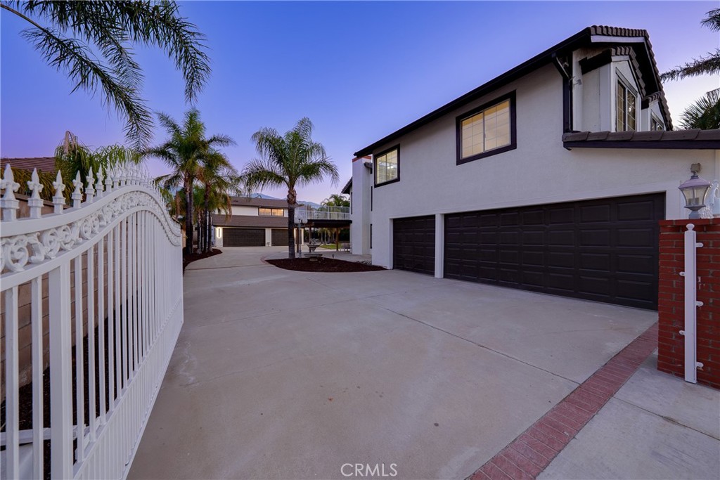 12982 Arapaho Road Rancho Cucamonga, CA 91739 - Photo 5 of 51 a view of a house with a yard and garage