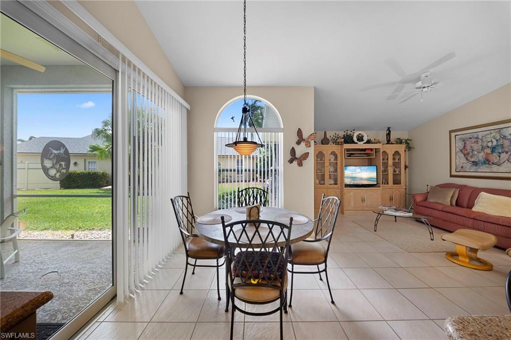 3971 Spring Garden Lane Estero, FL 33928 - Photo 30 of 31 a dining room with furniture and a floor to ceiling window