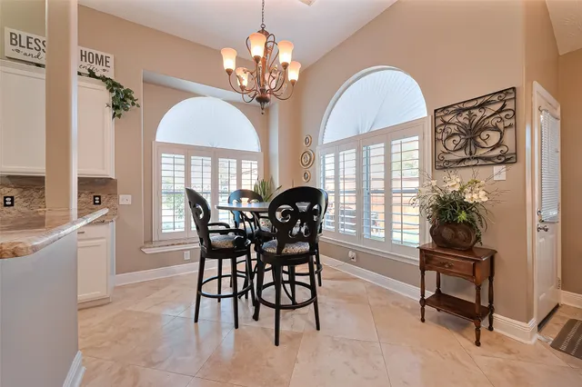 a view of a dining room with furniture and a chandelier