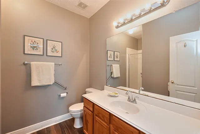 a bathroom with a sink toilet and mirror