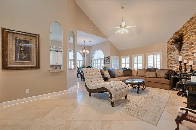 a living room with furniture and a chandelier