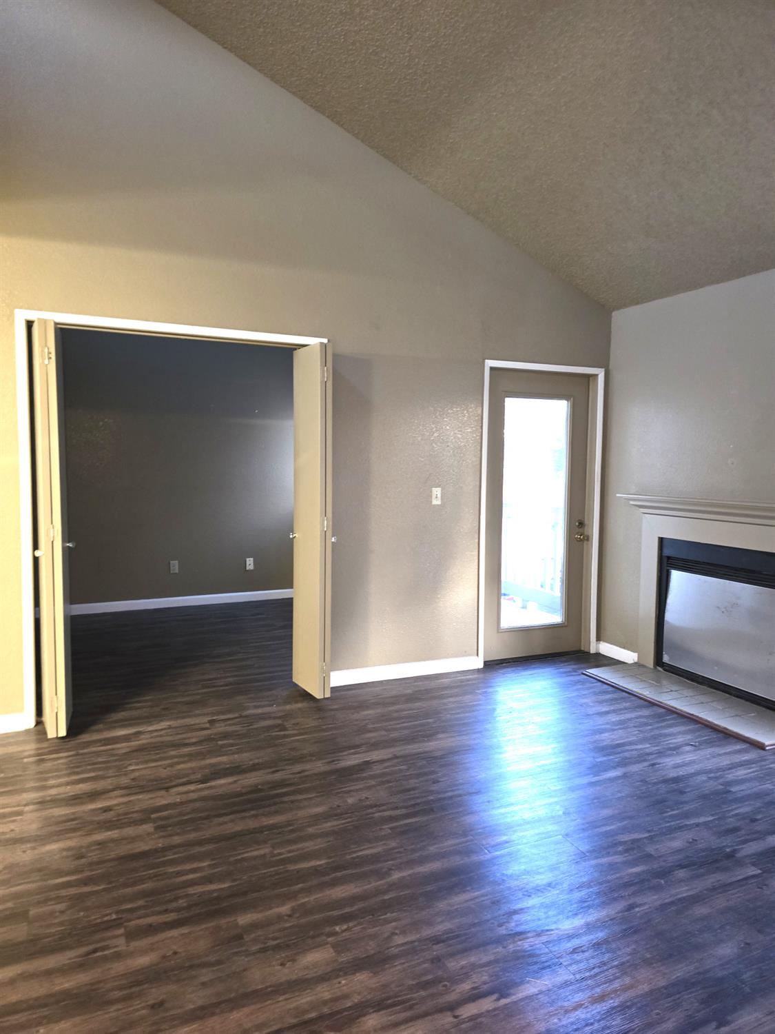 3939 Madison Avenue, Unit 220 North Highlands, CA 95660 - Photo 2 of 12 an empty room with wooden floor and windows