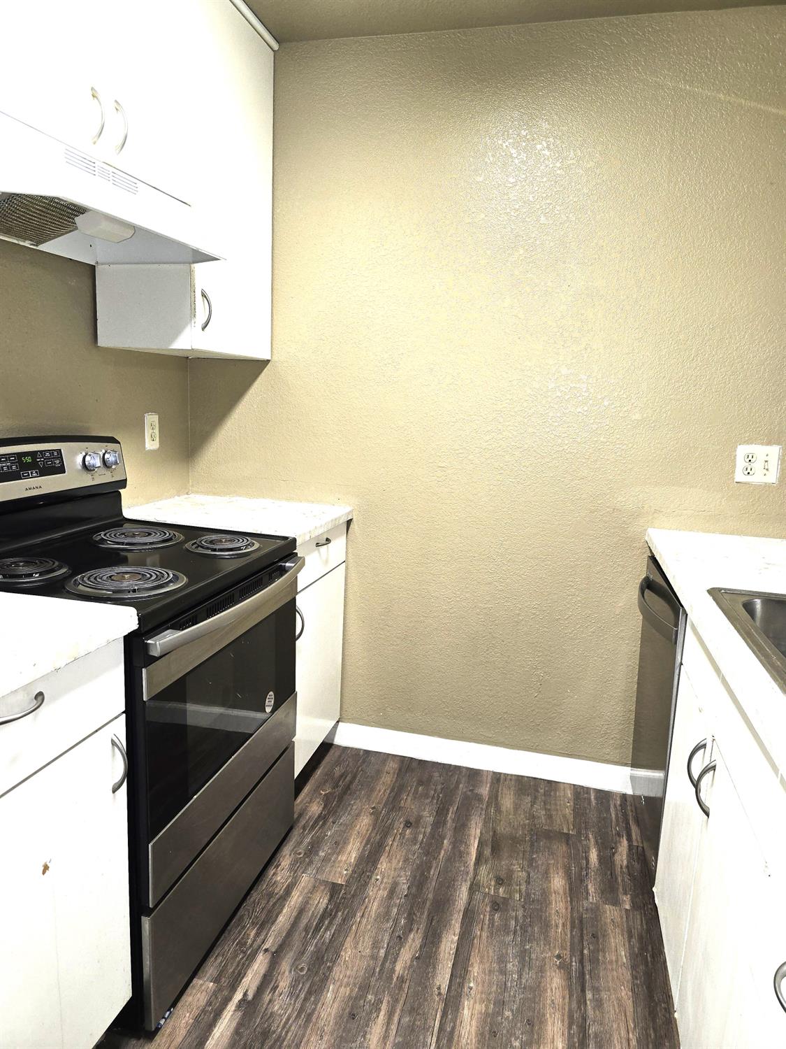 3939 Madison Avenue, Unit 220 North Highlands, CA 95660 - Photo 6 of 12 a stove top oven sitting inside of a kitchen