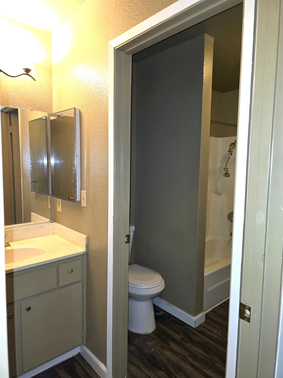 3939 Madison Avenue, Unit 220 North Highlands, CA 95660 - Photo 7 of 12 a bathroom with a granite countertop sink toilet and shower
