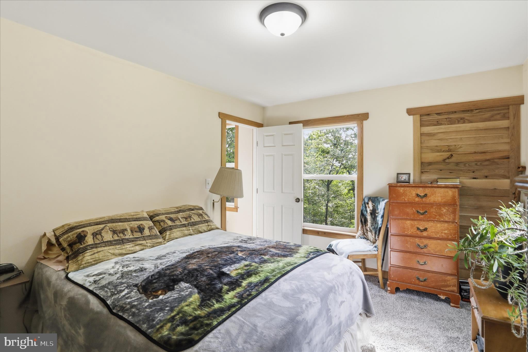 936 Johnny Cake Road Great Cacapon, WV 25422 - Photo 13 of 33 a bedroom with a bed and a window