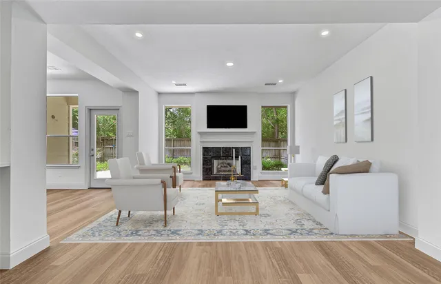 a living room with fireplace furniture and a flat screen tv