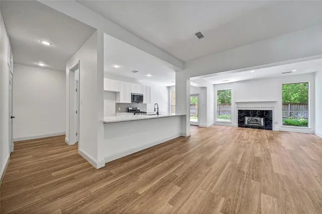 a view of kitchen with granite countertop cabinets and wooden floor
