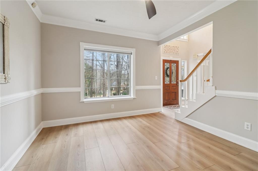 175 Meredith Way Stockbridge, GA 30281 - Photo 12 of 75 a view of an empty room with wooden floor and a window
