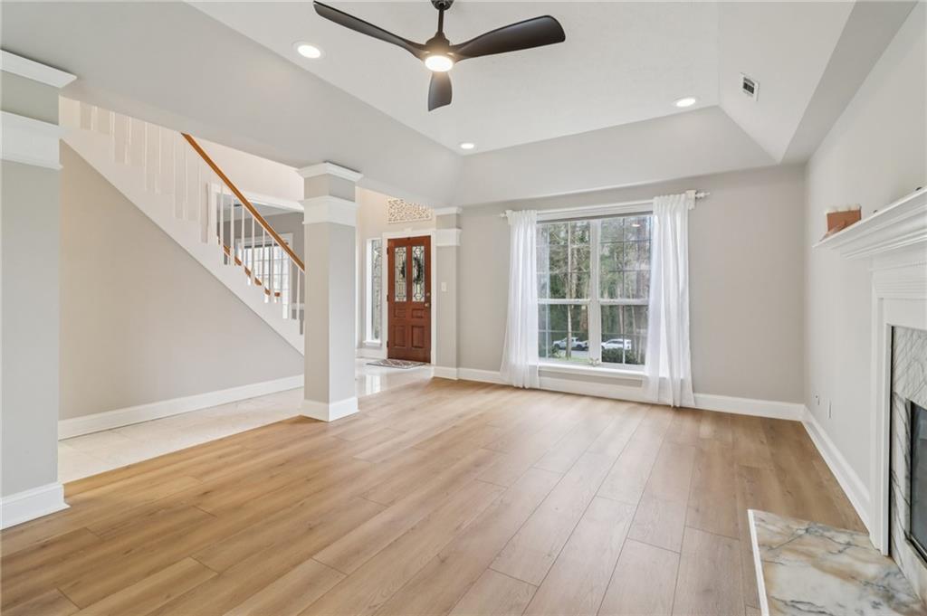 175 Meredith Way Stockbridge, GA 30281 - Photo 14 of 75 a view of an empty room with wooden floor and a window