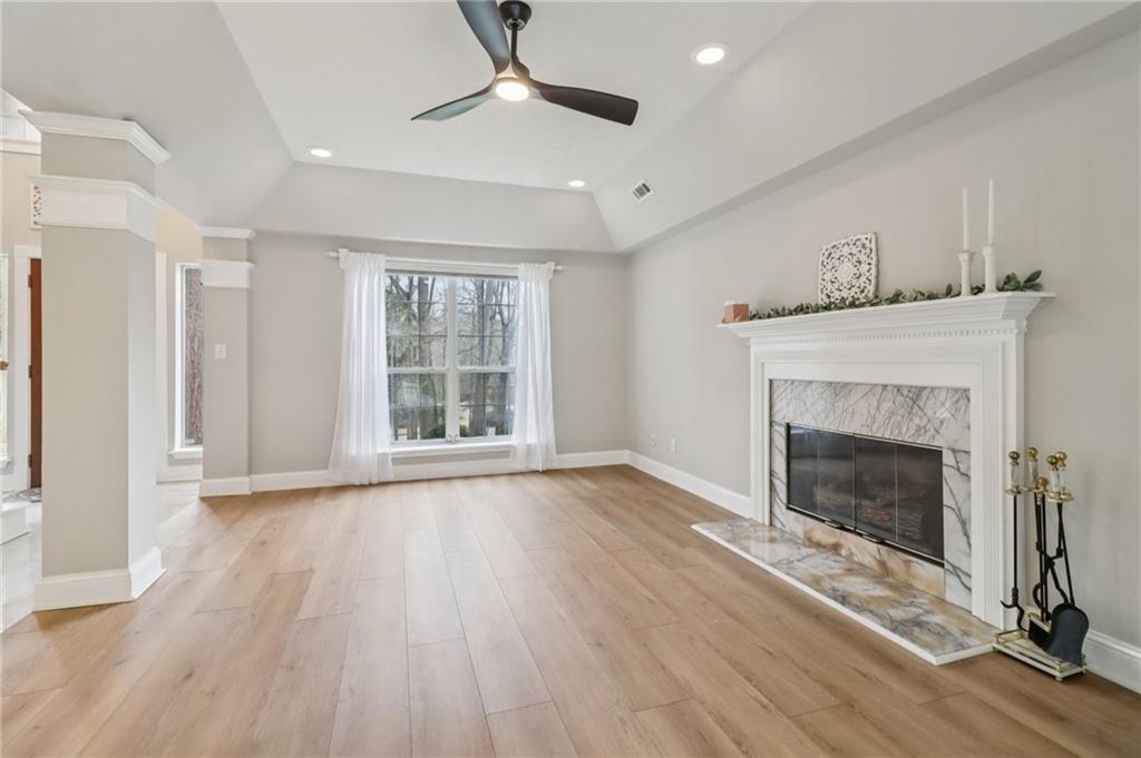 175 Meredith Way Stockbridge, GA 30281 - Photo 15 of 75 a view of an empty room with wooden floor fireplace and a window