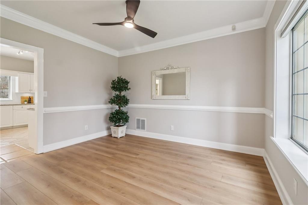 175 Meredith Way Stockbridge, GA 30281 - Photo 16 of 75 a view of empty room with wooden floor and fan