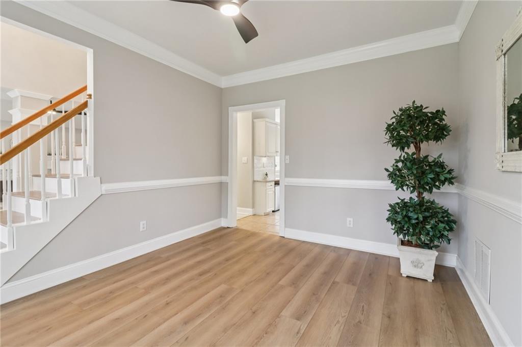 175 Meredith Way Stockbridge, GA 30281 - Photo 18 of 75 a view of an empty room with a window and wooden floor