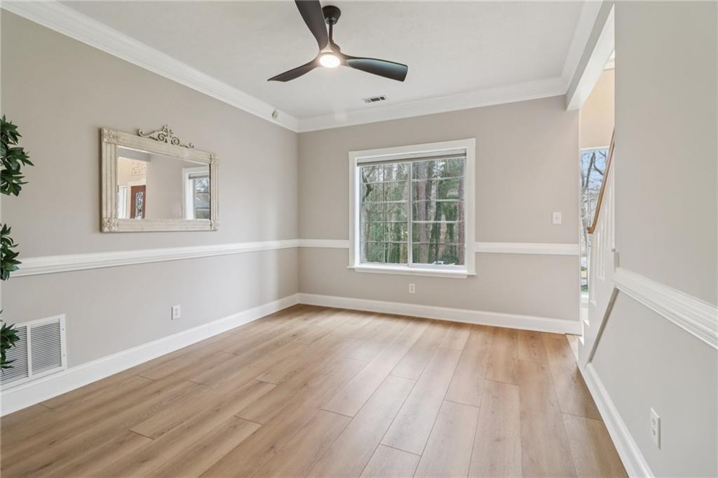 175 Meredith Way Stockbridge, GA 30281 - Photo 19 of 75 a view of an empty room with wooden floor and a window