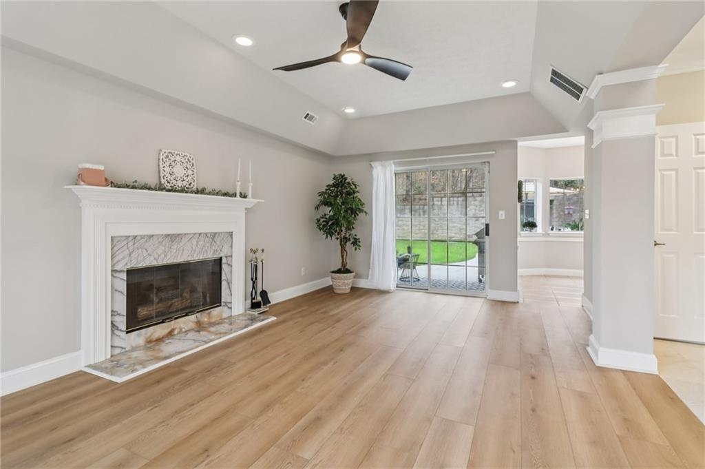 175 Meredith Way Stockbridge, GA 30281 - Photo 20 of 75 a view of a livingroom with wooden floor a fireplace and window