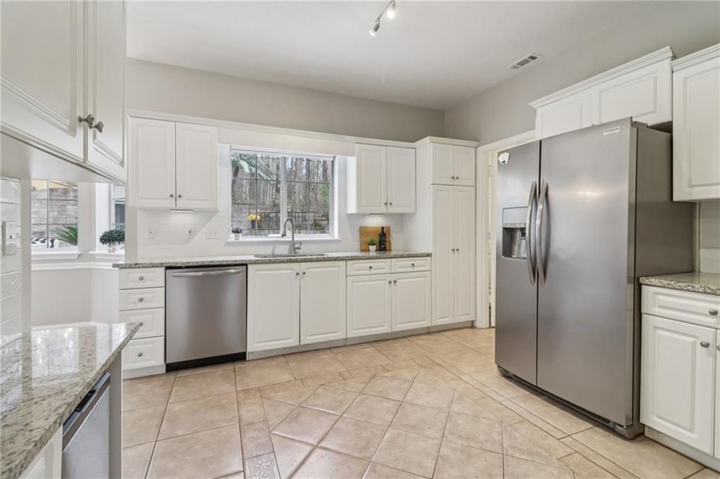 175 Meredith Way Stockbridge, GA 30281 - Photo 24 of 75 a kitchen with a refrigerator sink and cabinets
