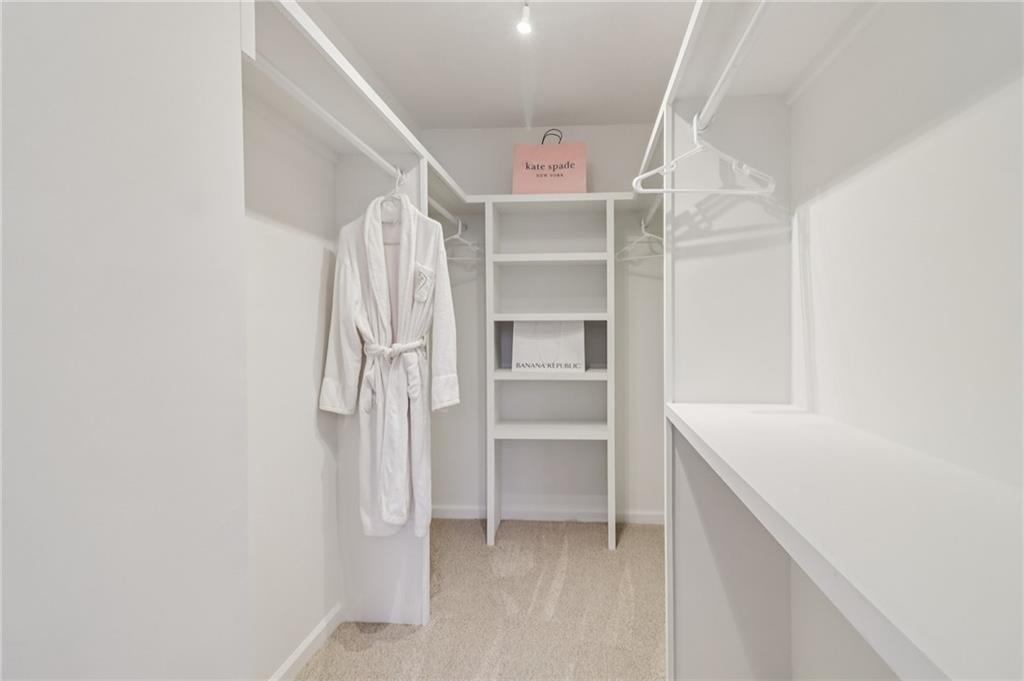 175 Meredith Way Stockbridge, GA 30281 - Photo 34 of 75 a view of walk in closet with empty racks