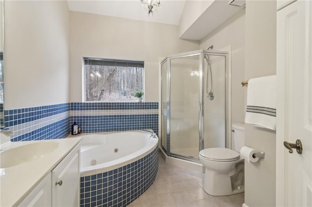 175 Meredith Way Stockbridge, GA 30281 - Photo 36 of 75 a bathroom with a granite countertop bathtub shower and toilet