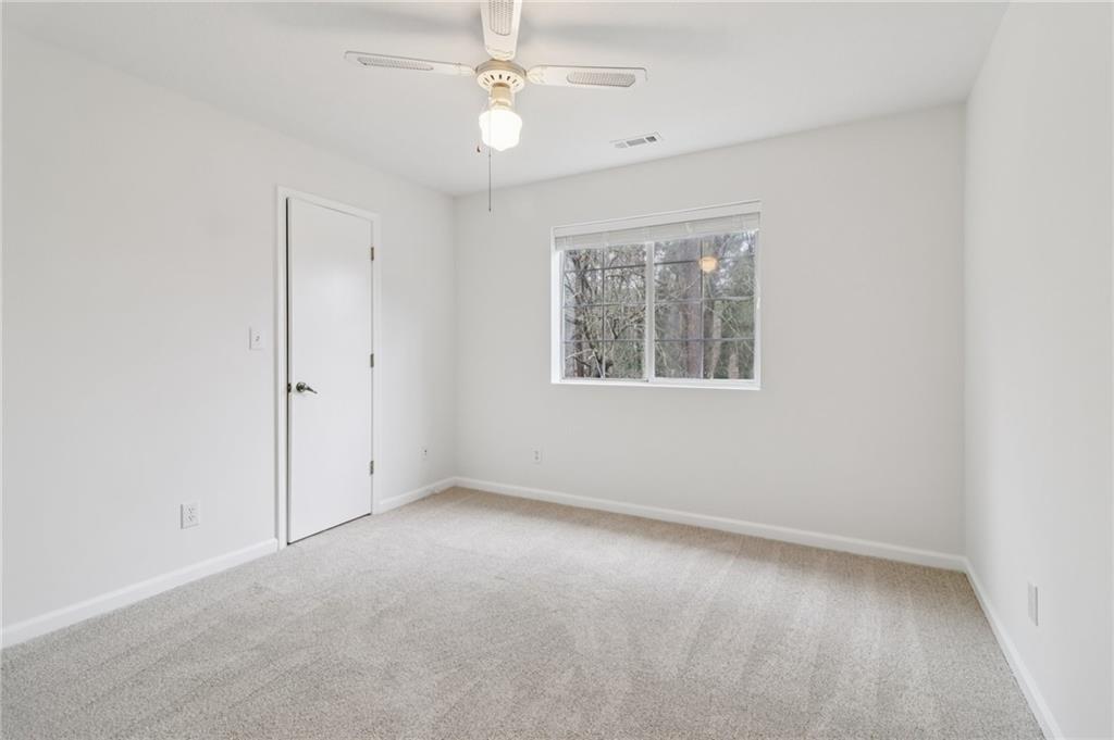 175 Meredith Way Stockbridge, GA 30281 - Photo 48 of 75 an empty room with a window and a fan