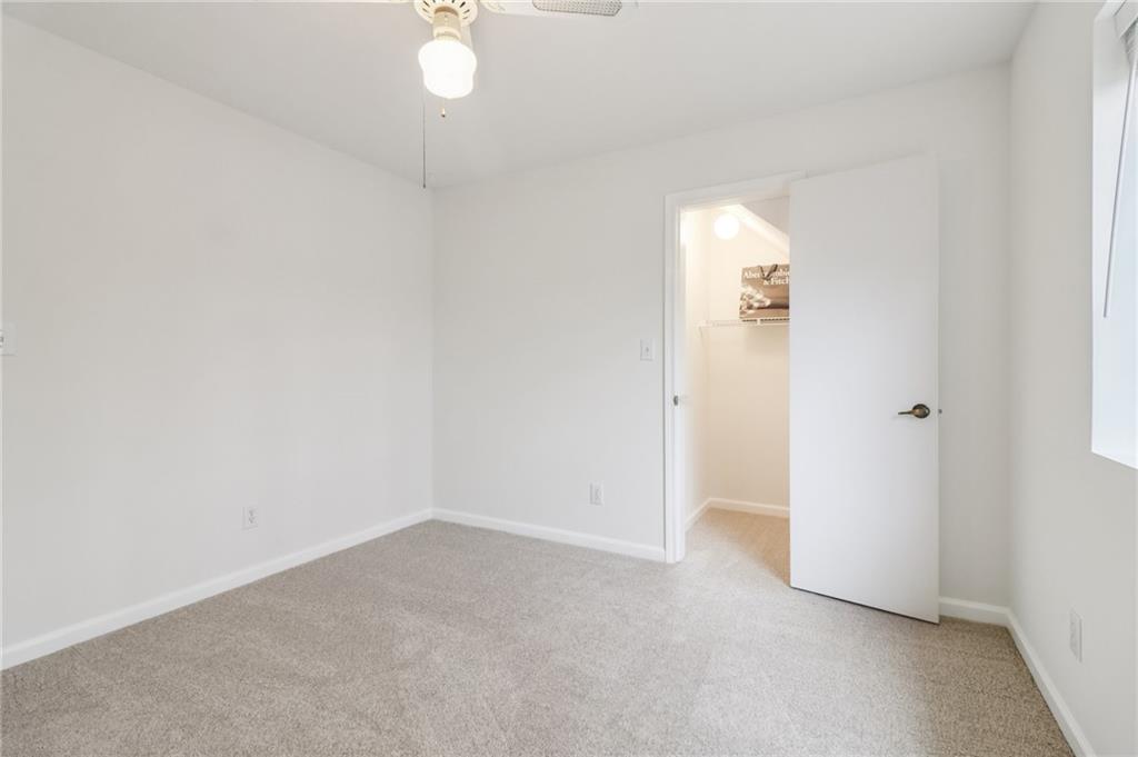 175 Meredith Way Stockbridge, GA 30281 - Photo 50 of 75 an empty room with a window and a chandelier fan