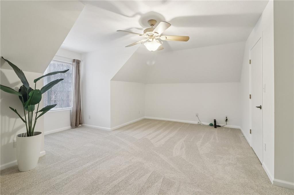 175 Meredith Way Stockbridge, GA 30281 - Photo 54 of 75 an empty room with potted plants and a chandelier fan