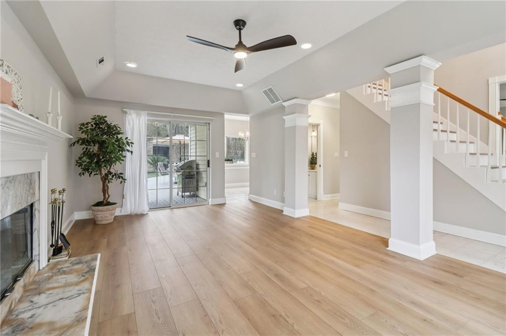 175 Meredith Way Stockbridge, GA 30281 - Photo 6 of 75 a view of a livingroom with wooden floor a ceiling fan and windows