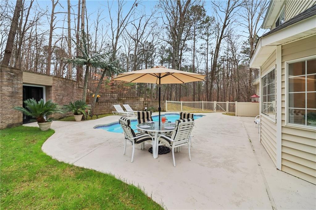 175 Meredith Way Stockbridge, GA 30281 - Photo 7 of 75 a patio with a table and chairs under an umbrella