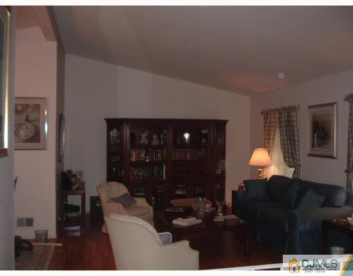 14 Peake Road Edison, NJ 08837 - Photo 3 of 8 a living room with furniture a lamp and a fireplace