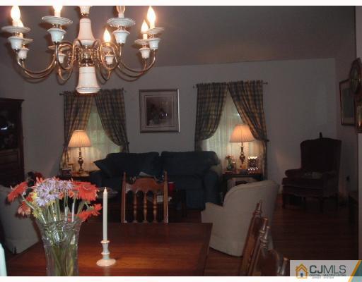14 Peake Road Edison, NJ 08837 - Photo 8 of 8 a living room with furniture chandelier and a window