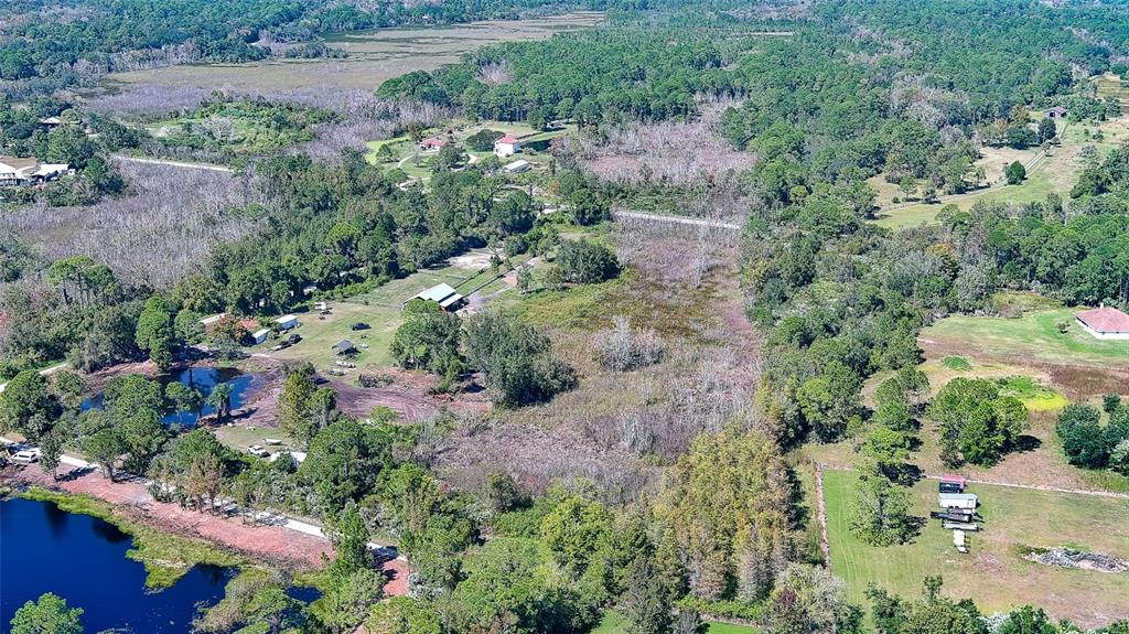 806 West Ariel Road Edgewater, FL 32141 - Photo 7 of 12 an aerial view of residential house with outdoor space and trees all around