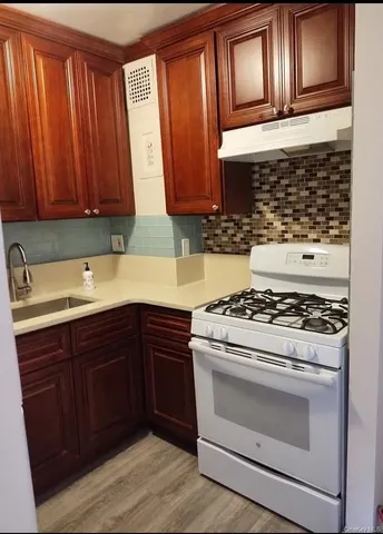 a kitchen with granite countertop wooden cabinets and stainless steel appliances