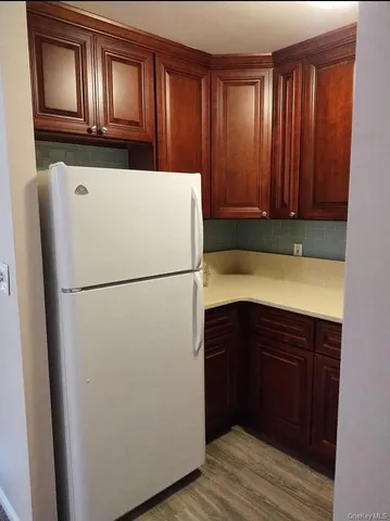 a kitchen with a refrigerator and cabinets