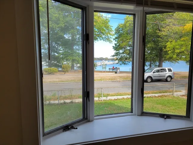 a view of a room and floor to ceiling window next to a yard