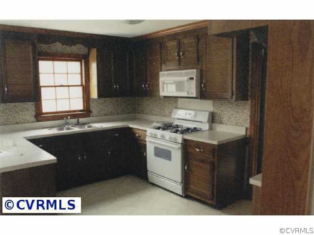1107 Kingscross Road Midlothian, VA 23114 - Photo 3 of 4 a kitchen with a sink stove and cabinets